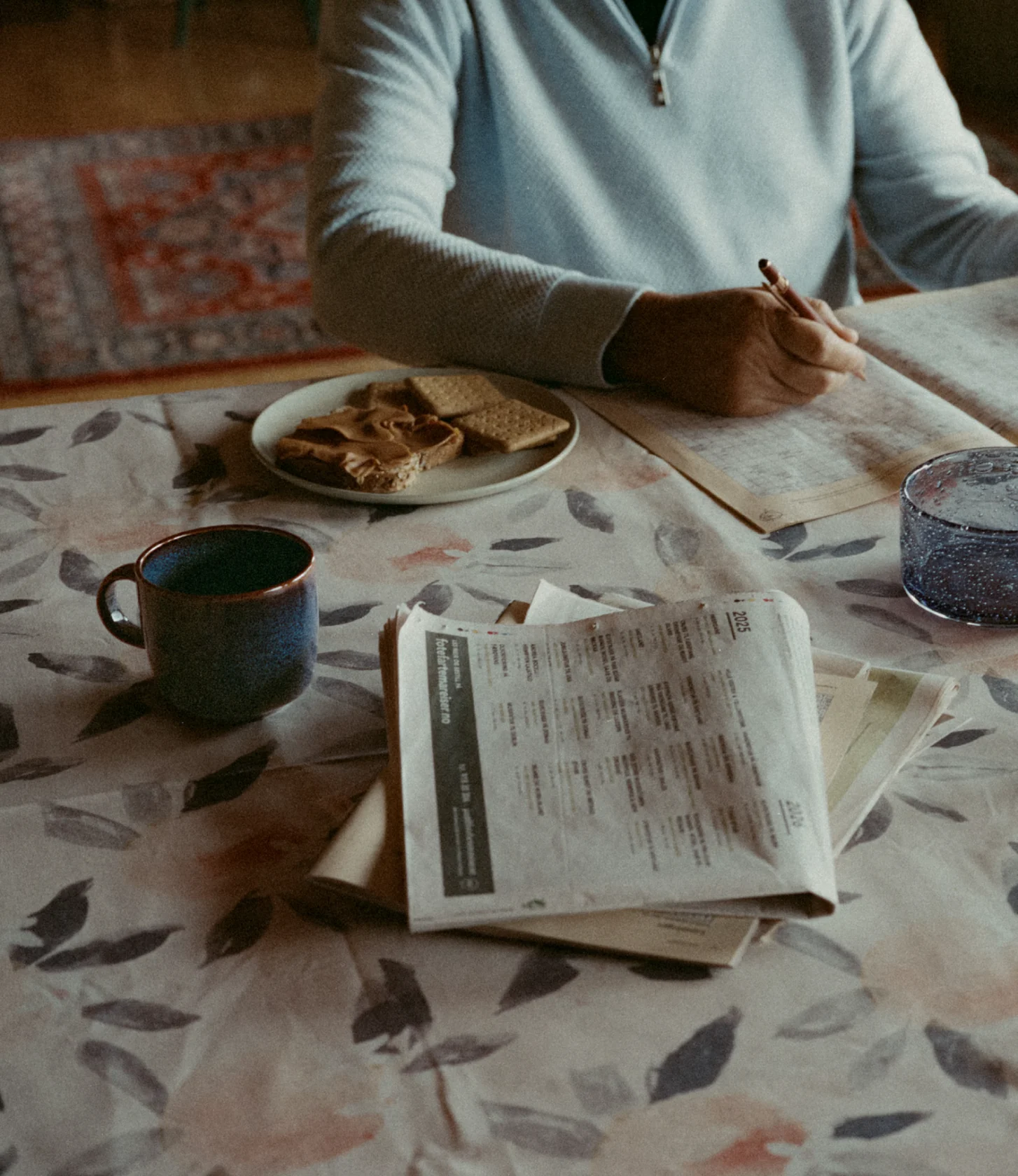 Still from the campaign: a table with newspapers and coffee